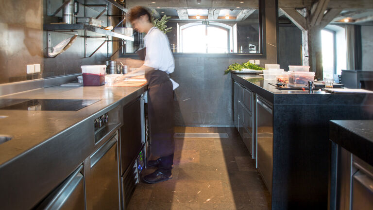 Chef in restaurant kitchen preparing food